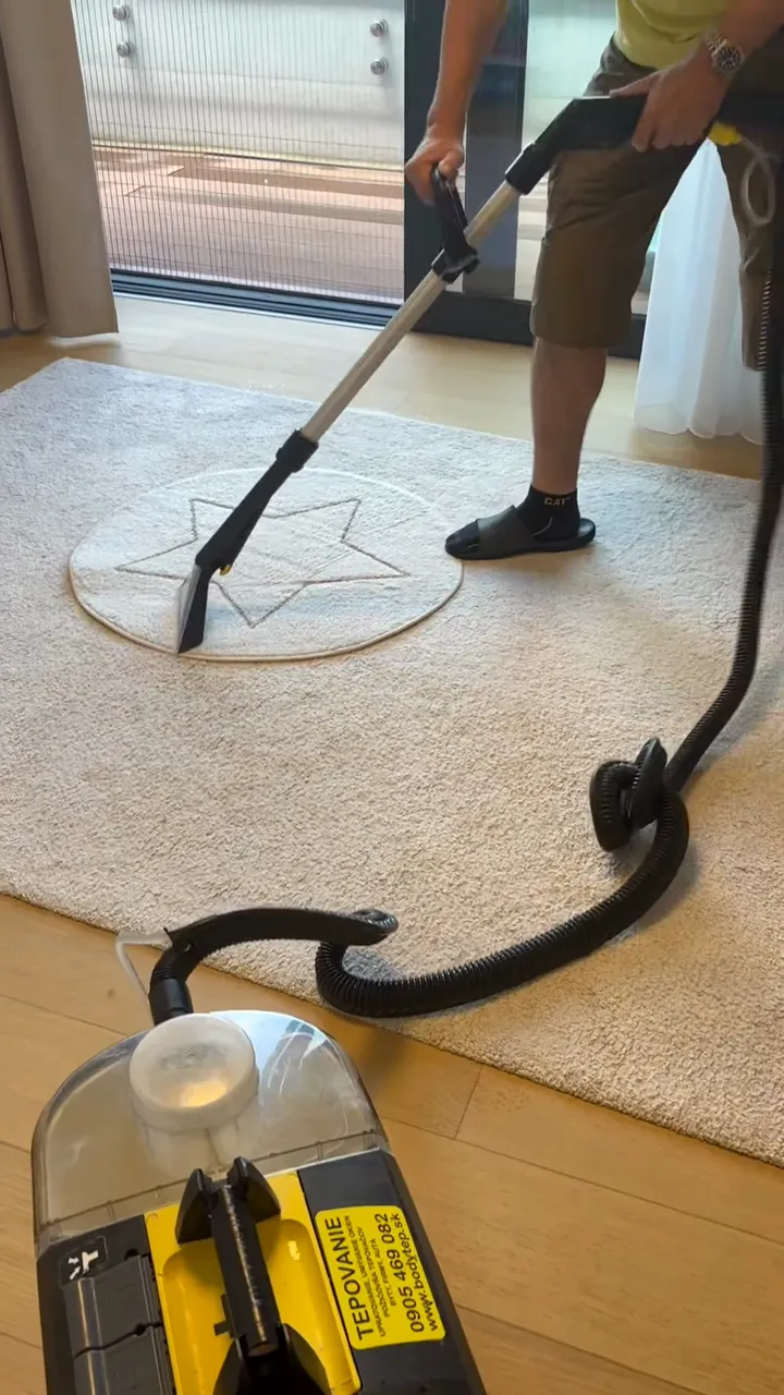 Video: pracovník tepuje podlahovou hubicou svetlý koberec s hviezdou